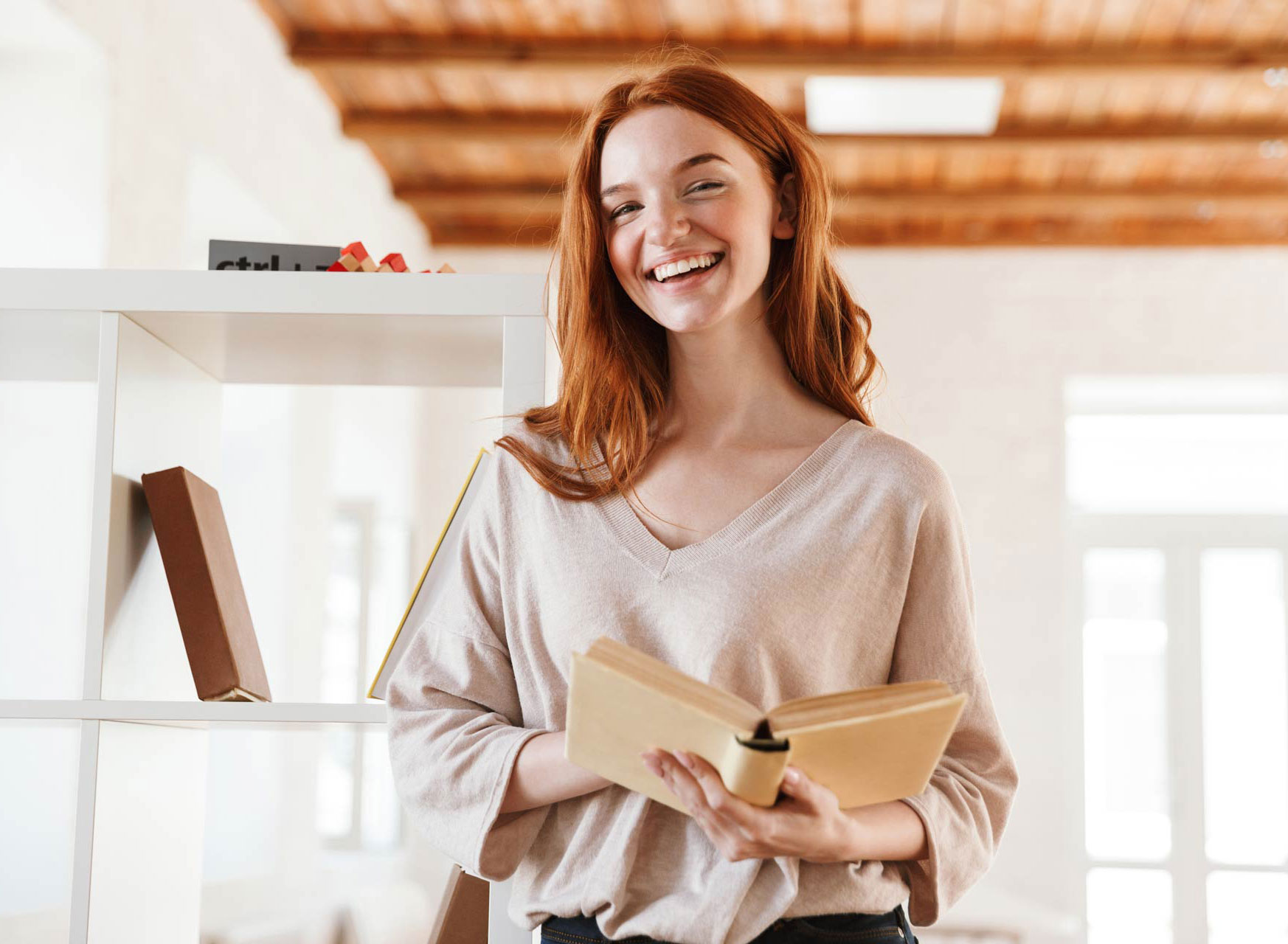 happy-redhead-young-lady-student-reading-book-look-M5Z7RVC.jpg